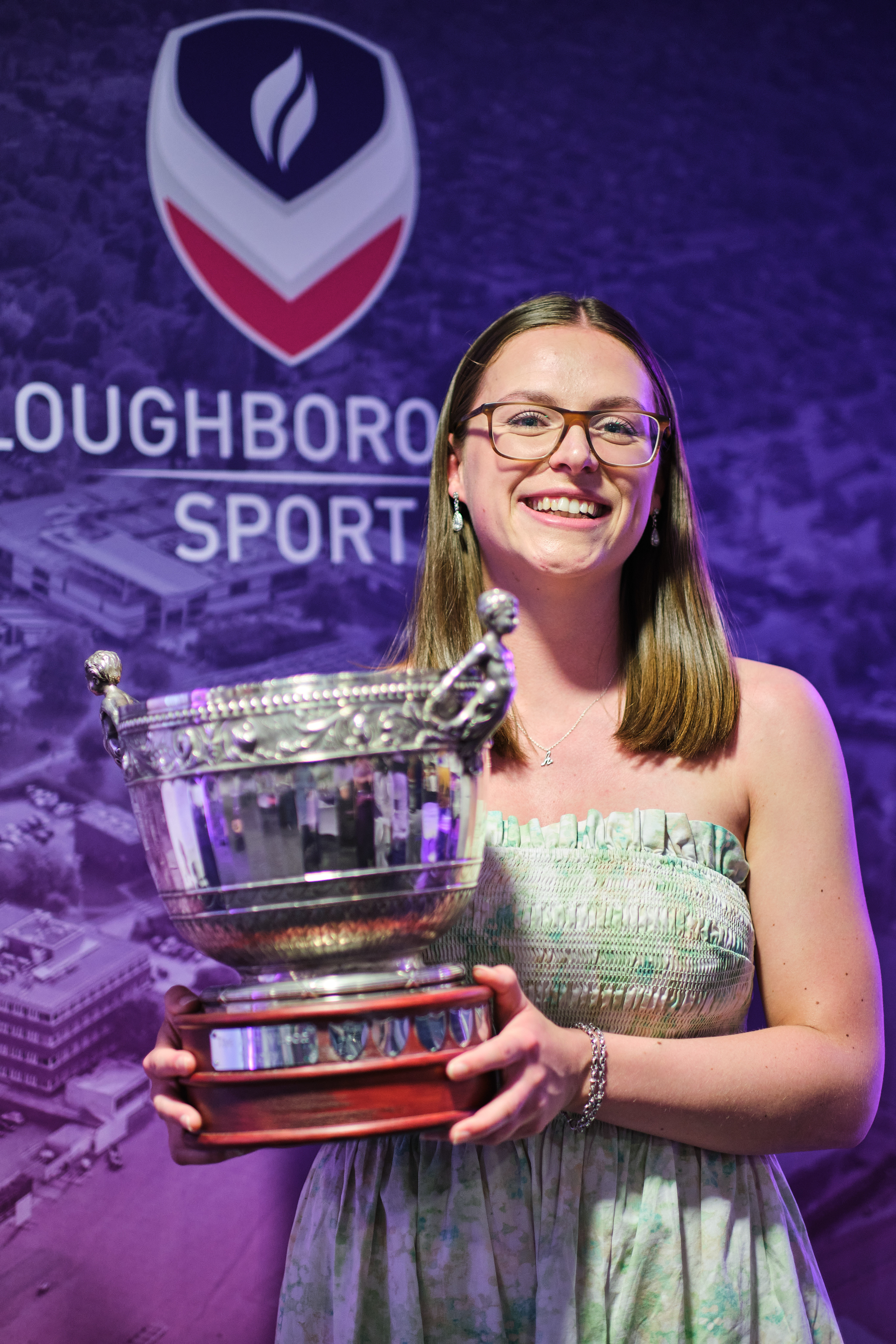 Hannah Bashford holding the Ann Wilson trophy for outstanding achievement contribution to Loughborough's Athletic Union after winning it at AU Colours. 